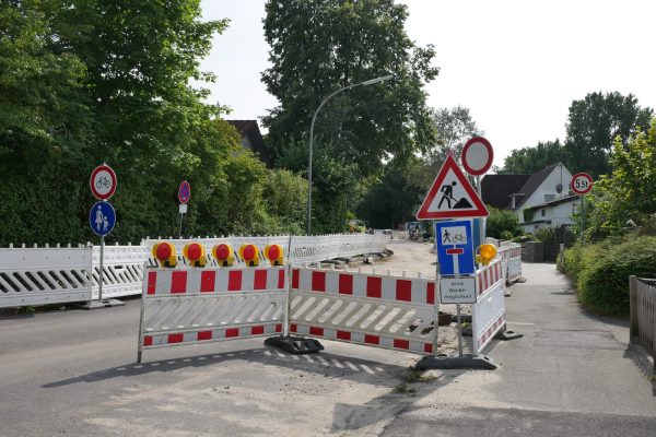 a road closed off with barricades and signs