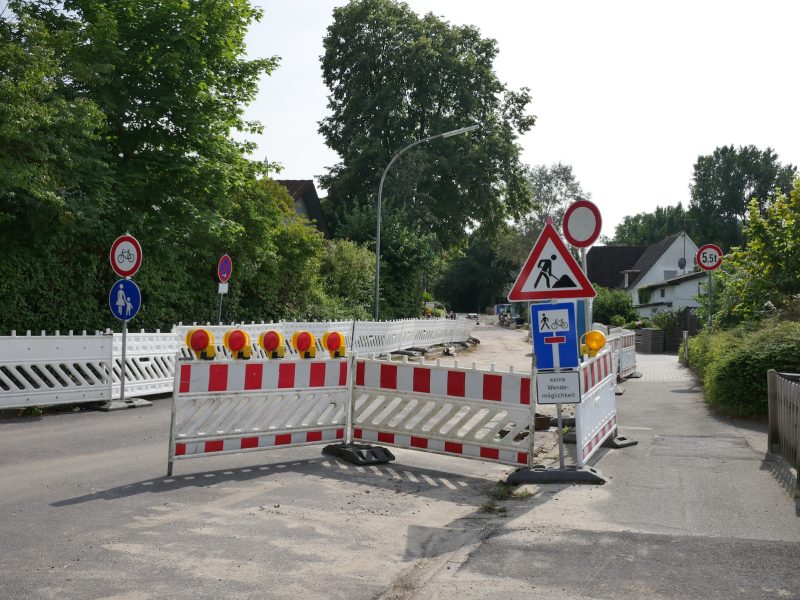 a road closed off with barricades and signs